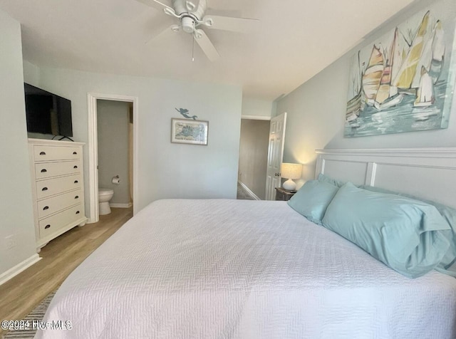 bedroom featuring ensuite bath, ceiling fan, and hardwood / wood-style flooring