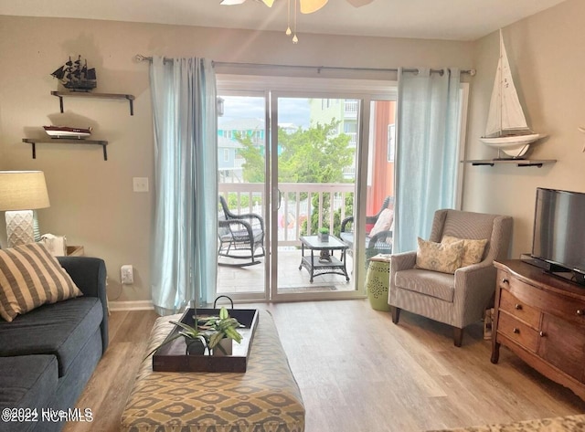 living room with hardwood / wood-style floors and ceiling fan