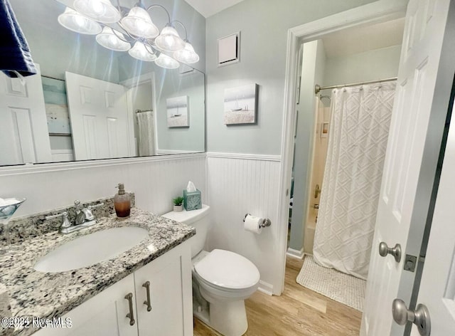 full bathroom featuring hardwood / wood-style floors, vanity, toilet, and shower / bath combo