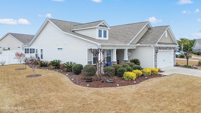 view of front of house featuring a garage and a front lawn