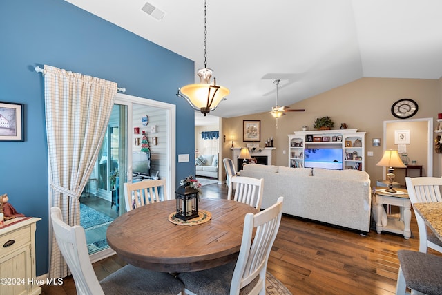 dining room with dark hardwood / wood-style floors, ceiling fan, and vaulted ceiling