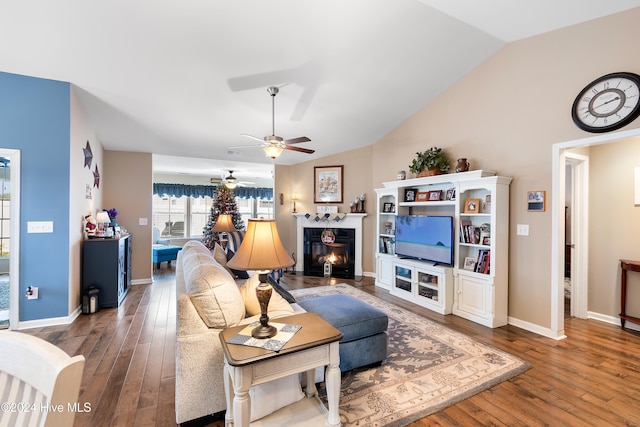 living room with hardwood / wood-style floors, ceiling fan, and vaulted ceiling