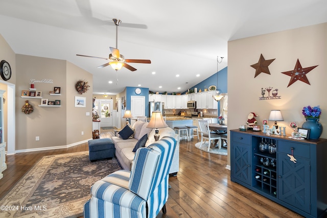 living room with dark wood-type flooring, ceiling fan, and lofted ceiling