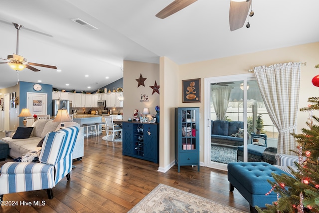 living room with dark hardwood / wood-style flooring, vaulted ceiling, and ceiling fan