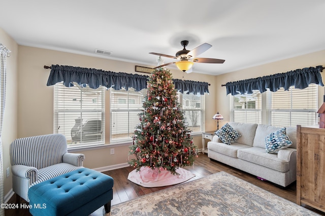 living room with ceiling fan and dark hardwood / wood-style flooring