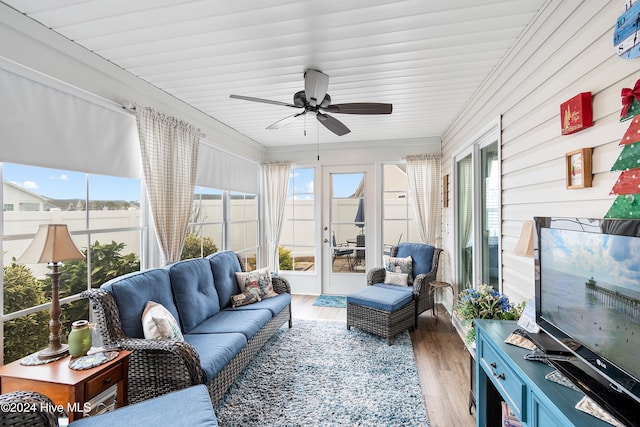 sunroom featuring ceiling fan