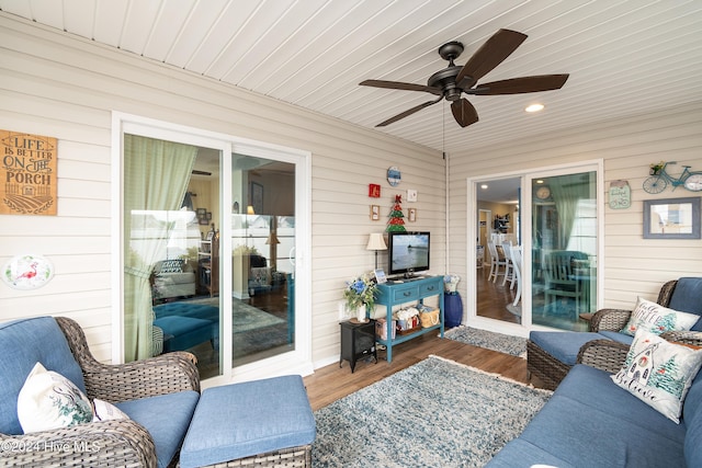 sunroom / solarium featuring ceiling fan and wood ceiling