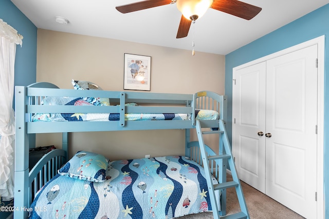 bedroom with carpet flooring, ceiling fan, and a closet