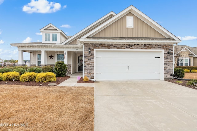 craftsman house featuring covered porch and a garage