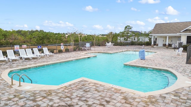 view of swimming pool with a patio