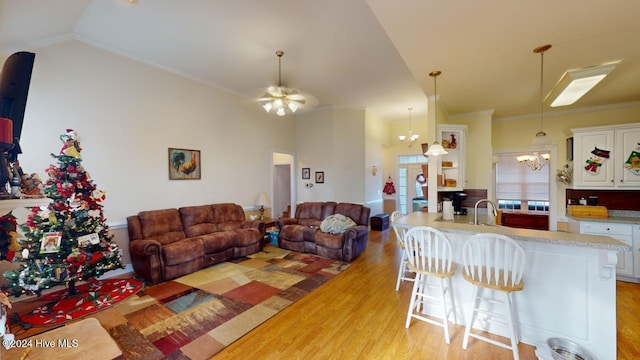 living room with french doors, crown molding, sink, light hardwood / wood-style flooring, and a notable chandelier