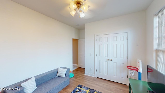 living area featuring ceiling fan and light hardwood / wood-style flooring