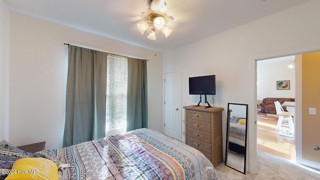 bedroom with light carpet and ceiling fan