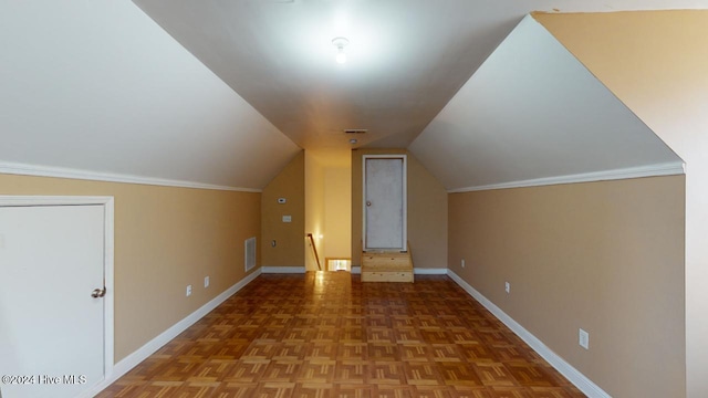 additional living space with parquet flooring and vaulted ceiling