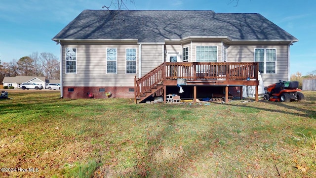 rear view of house featuring a lawn and a wooden deck