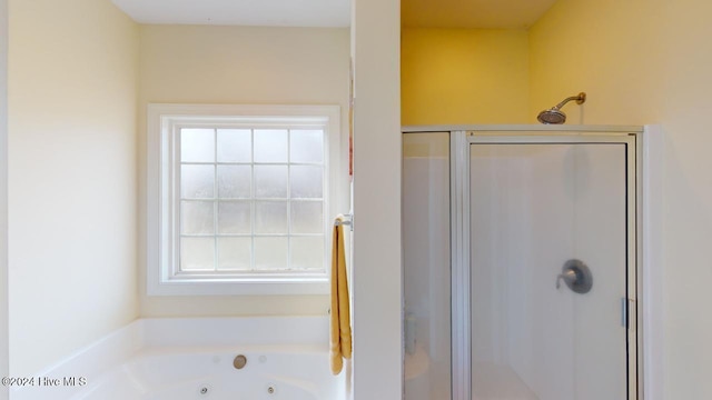 bathroom featuring separate shower and tub