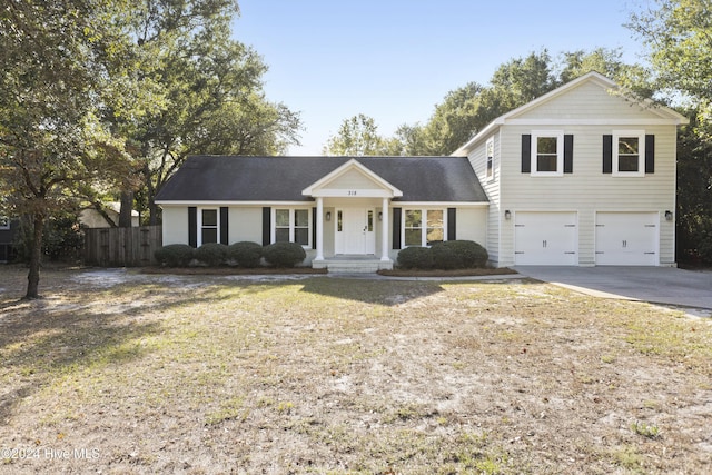 view of front of property featuring a front yard and a garage