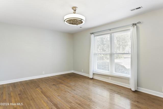 unfurnished room featuring hardwood / wood-style flooring