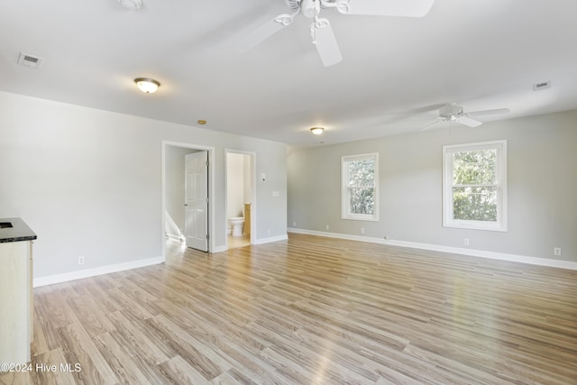 unfurnished room with ceiling fan and light wood-type flooring