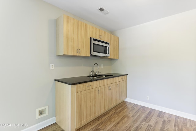 kitchen featuring sink, light brown cabinetry, and light hardwood / wood-style flooring