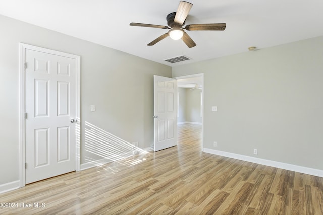 spare room featuring light wood-type flooring and ceiling fan