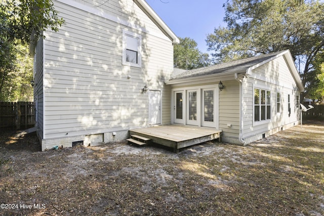 back of house featuring a wooden deck