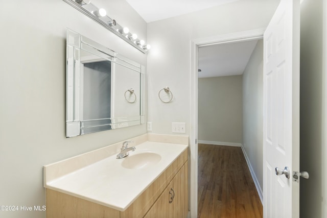 bathroom with hardwood / wood-style floors and vanity