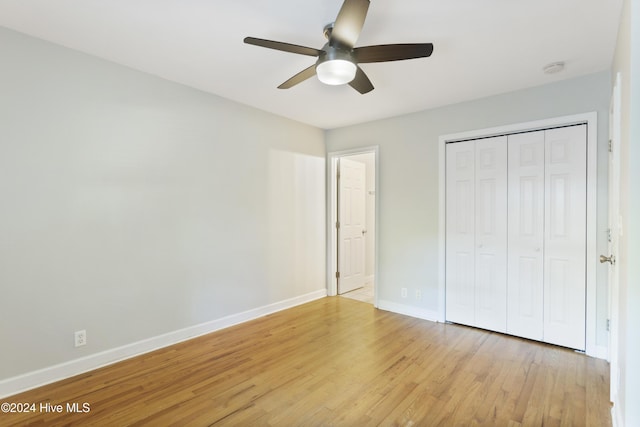 unfurnished bedroom with ceiling fan, light hardwood / wood-style floors, and a closet