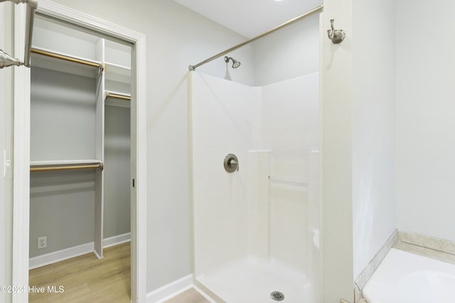 bathroom with hardwood / wood-style floors and walk in shower