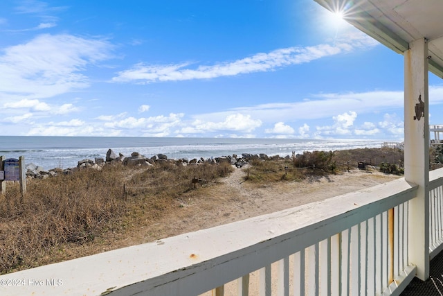 balcony with a beach view and a water view