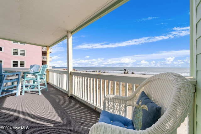 balcony with a view of the beach and a water view