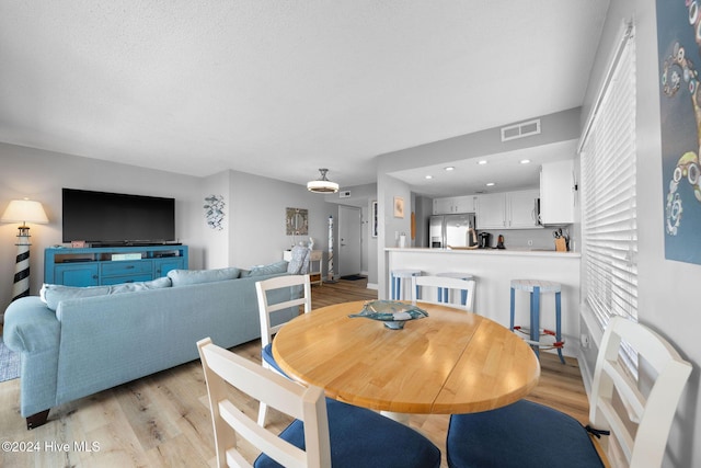 dining area with light hardwood / wood-style floors