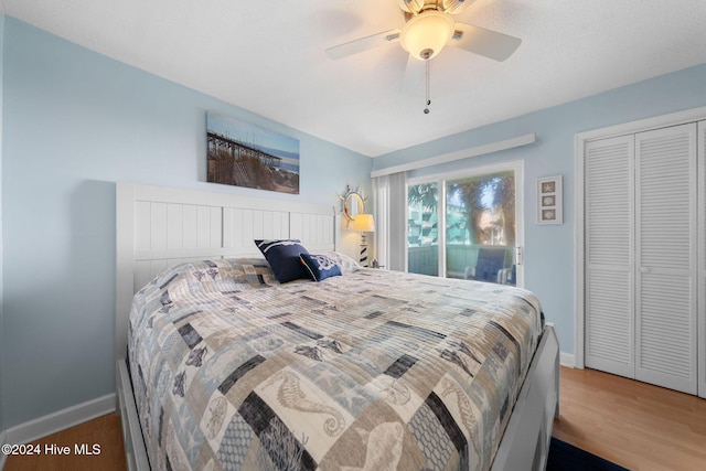 bedroom featuring hardwood / wood-style floors, a closet, and ceiling fan