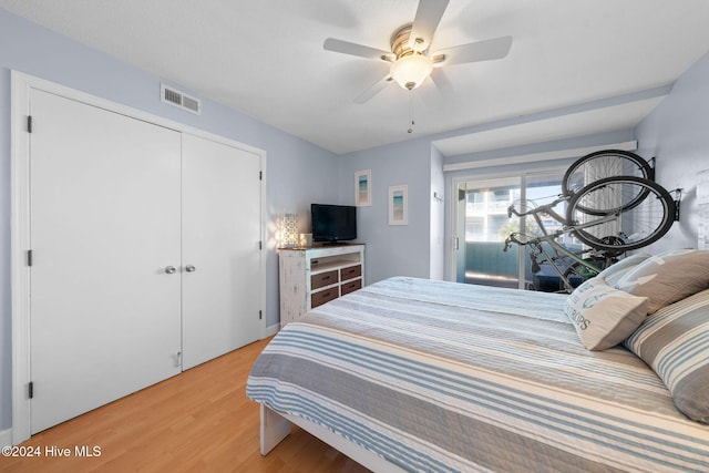 bedroom featuring light hardwood / wood-style floors, a closet, and ceiling fan