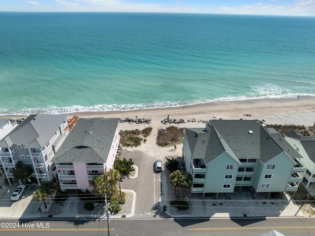 birds eye view of property with a water view and a view of the beach