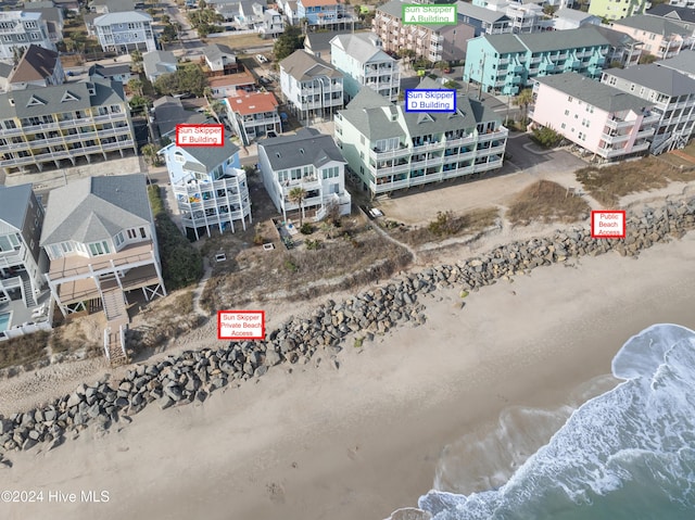 bird's eye view with a water view and a beach view