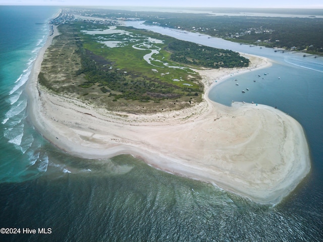 drone / aerial view featuring a water view and a view of the beach