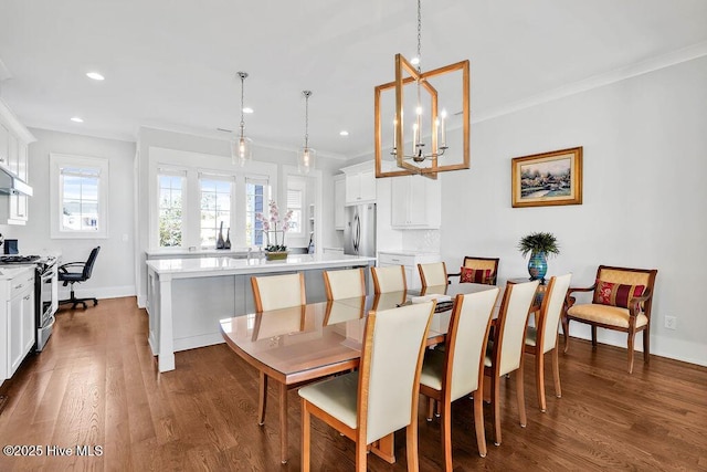 dining room featuring dark hardwood / wood-style floors, crown molding, and a notable chandelier