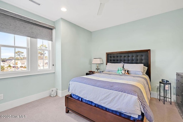 bedroom with ceiling fan and light carpet