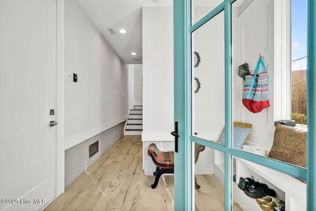 mudroom with light hardwood / wood-style flooring