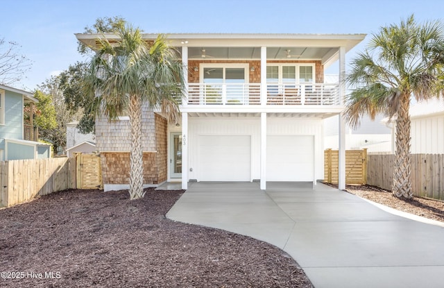 view of front of property featuring a balcony and a garage