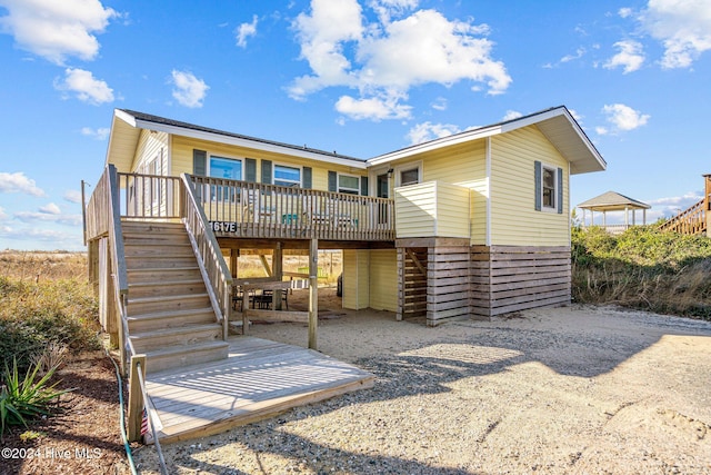 back of property featuring a wooden deck