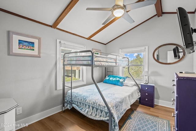 bedroom featuring hardwood / wood-style floors, lofted ceiling with beams, ceiling fan, and multiple windows