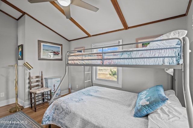 bedroom with ceiling fan, lofted ceiling, and hardwood / wood-style flooring