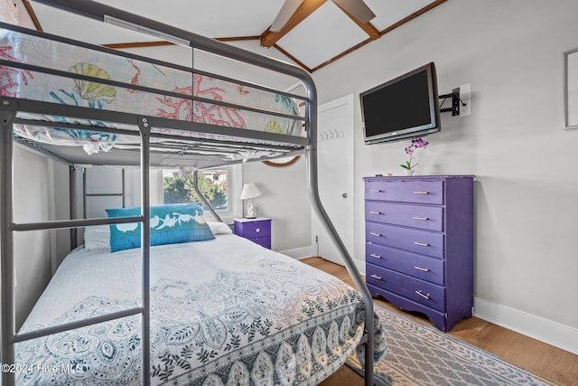 bedroom with hardwood / wood-style floors and vaulted ceiling