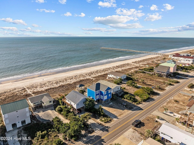 drone / aerial view featuring a beach view and a water view