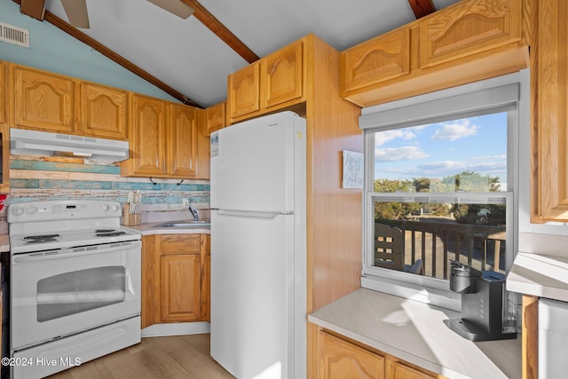 kitchen featuring tasteful backsplash, white appliances, sink, light hardwood / wood-style flooring, and lofted ceiling