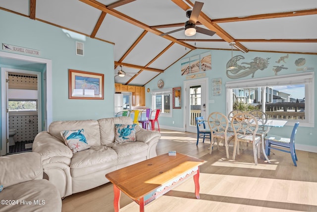 living room with beamed ceiling, ceiling fan, high vaulted ceiling, and light hardwood / wood-style flooring