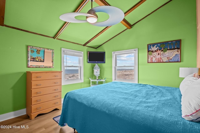 bedroom featuring ceiling fan, wood-type flooring, and vaulted ceiling