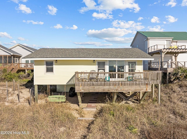 rear view of house featuring a deck